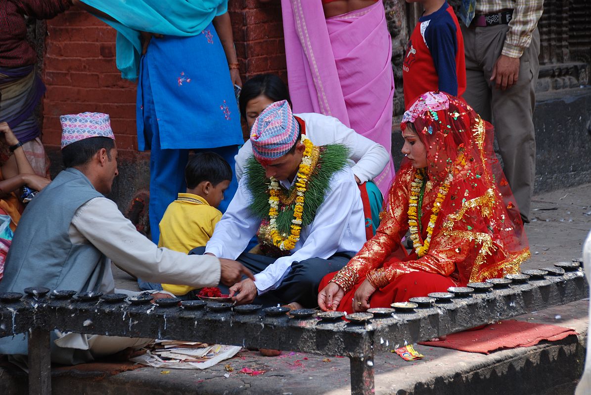 Kathmandu Patan 04 Kumbeshwar Temple 02 Hindu Wedding Ceremony I was lucky enough to see part of a Hindu wedding ceremony at the Kumbeshwar Temple in Patan. The groom wore a traditional garland of grass around his neck.